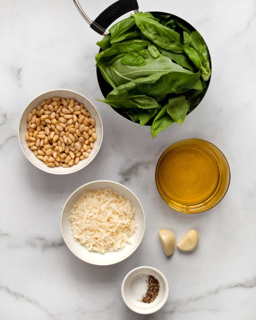 The Basics of Pesto: fresh basil, garlic, pine nuts, Parmesan cheese, and olive oil.