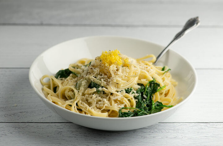 fettuccine pasta with grated Parmesan cheese and lemon