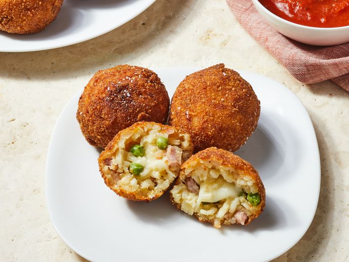 Popular Italian food originated in Sicily Arancini - those glorious golden orbs of fried rice goodnes